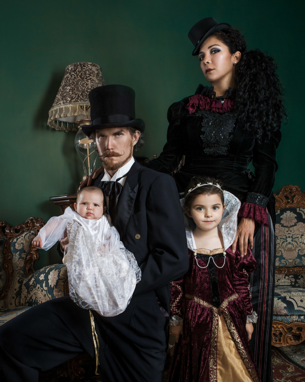 Victorian-style family portrait with parents, children and a baby in period dress