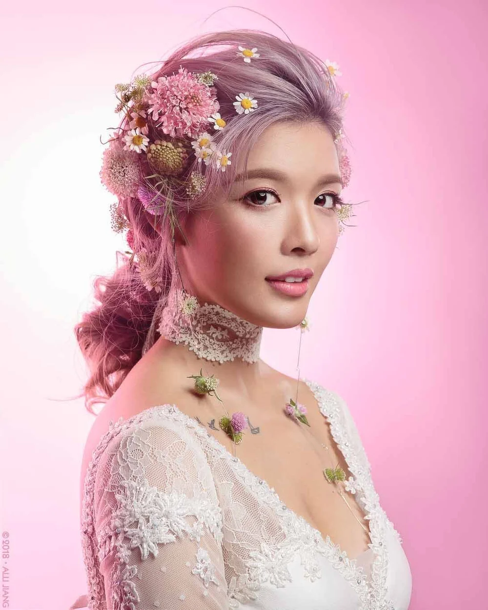 Beauty portrait with lavender hair and a floral headpiece, finished in the studio's signature style