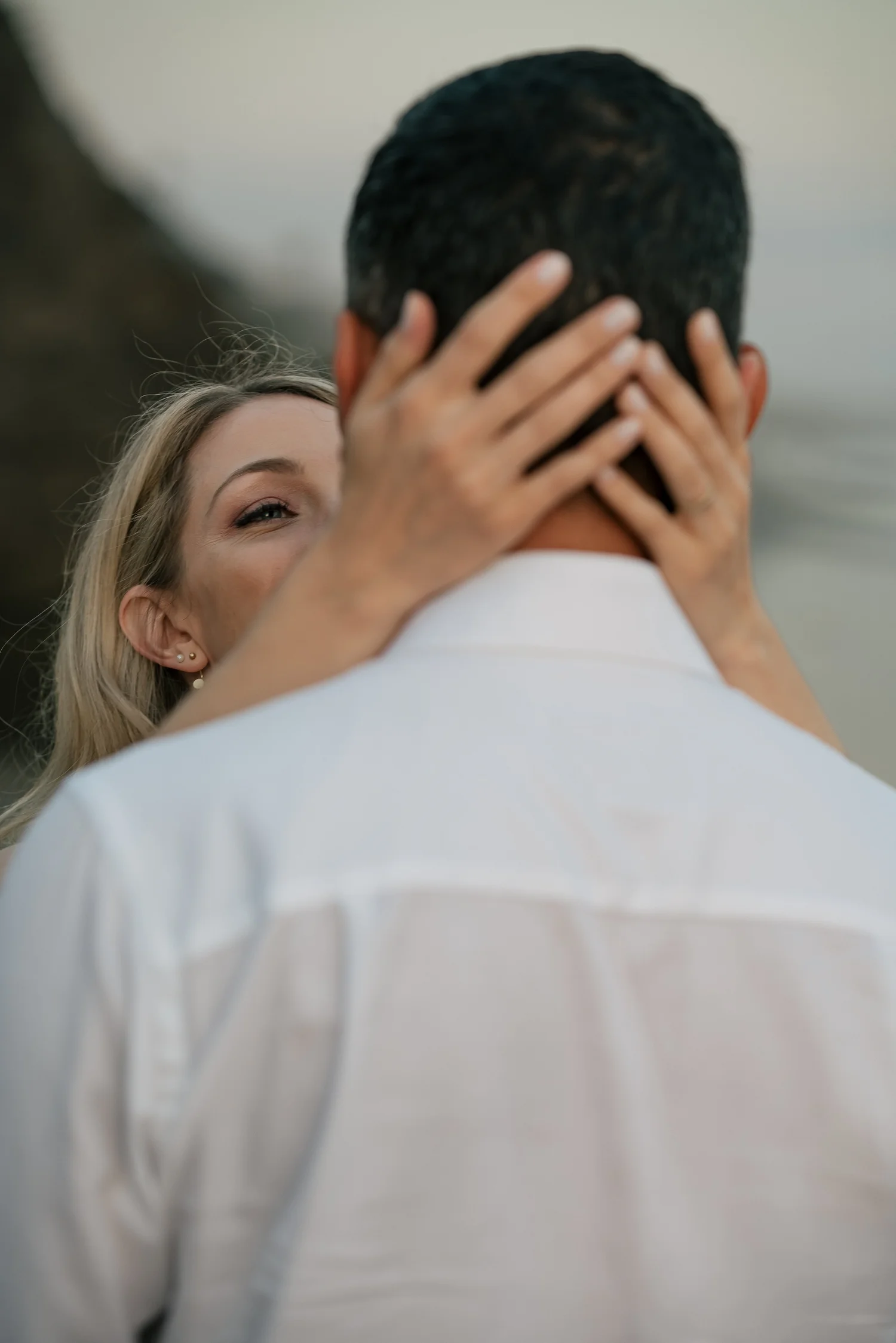 Couple exchanging vows on the sand between the sea stacks at a Malibu elopement