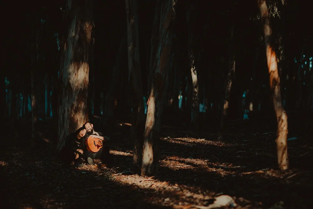Couple in a lantern-lit eucalyptus grove at night
