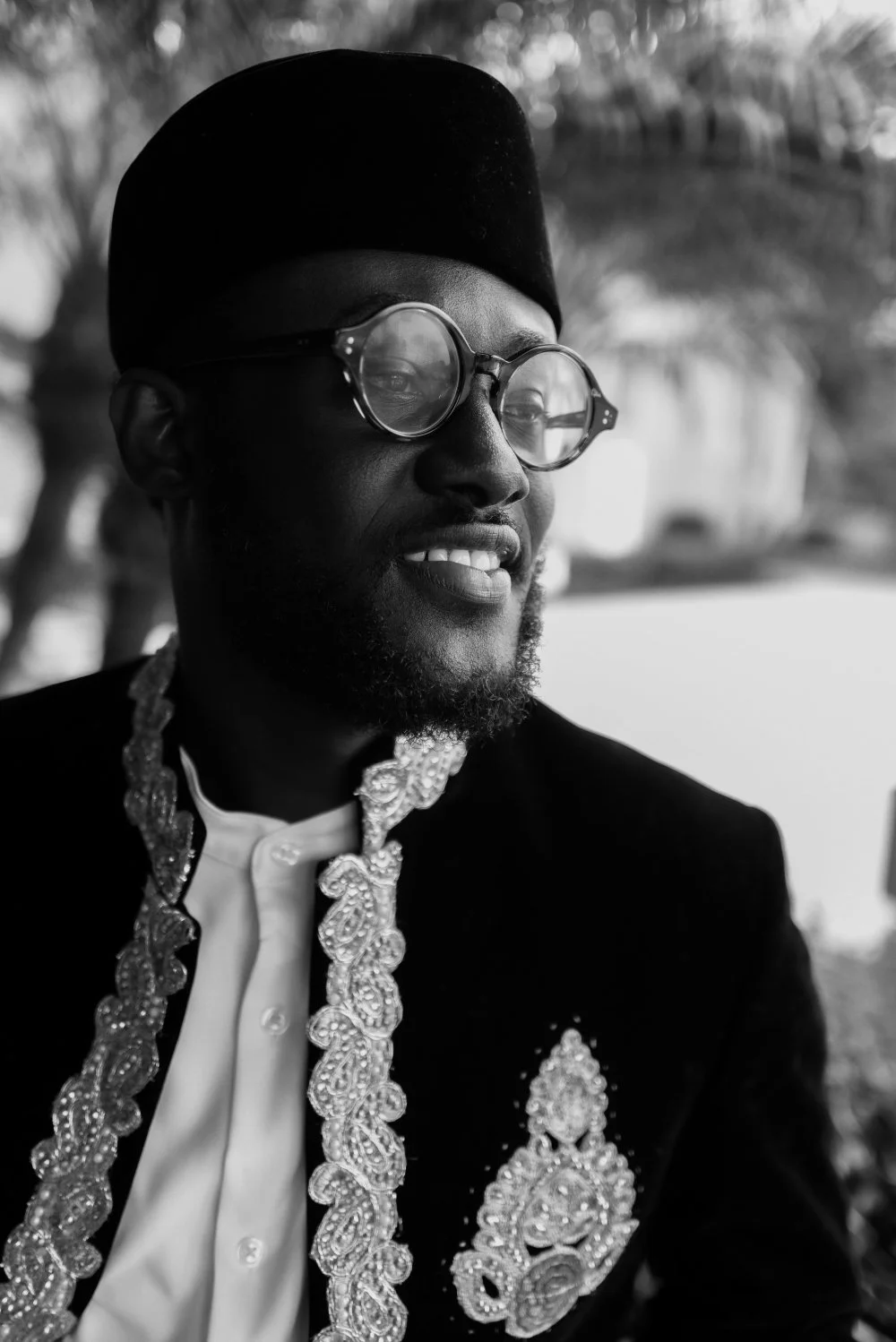 Groom in an embroidered coat and cap, a black-and-white portrait