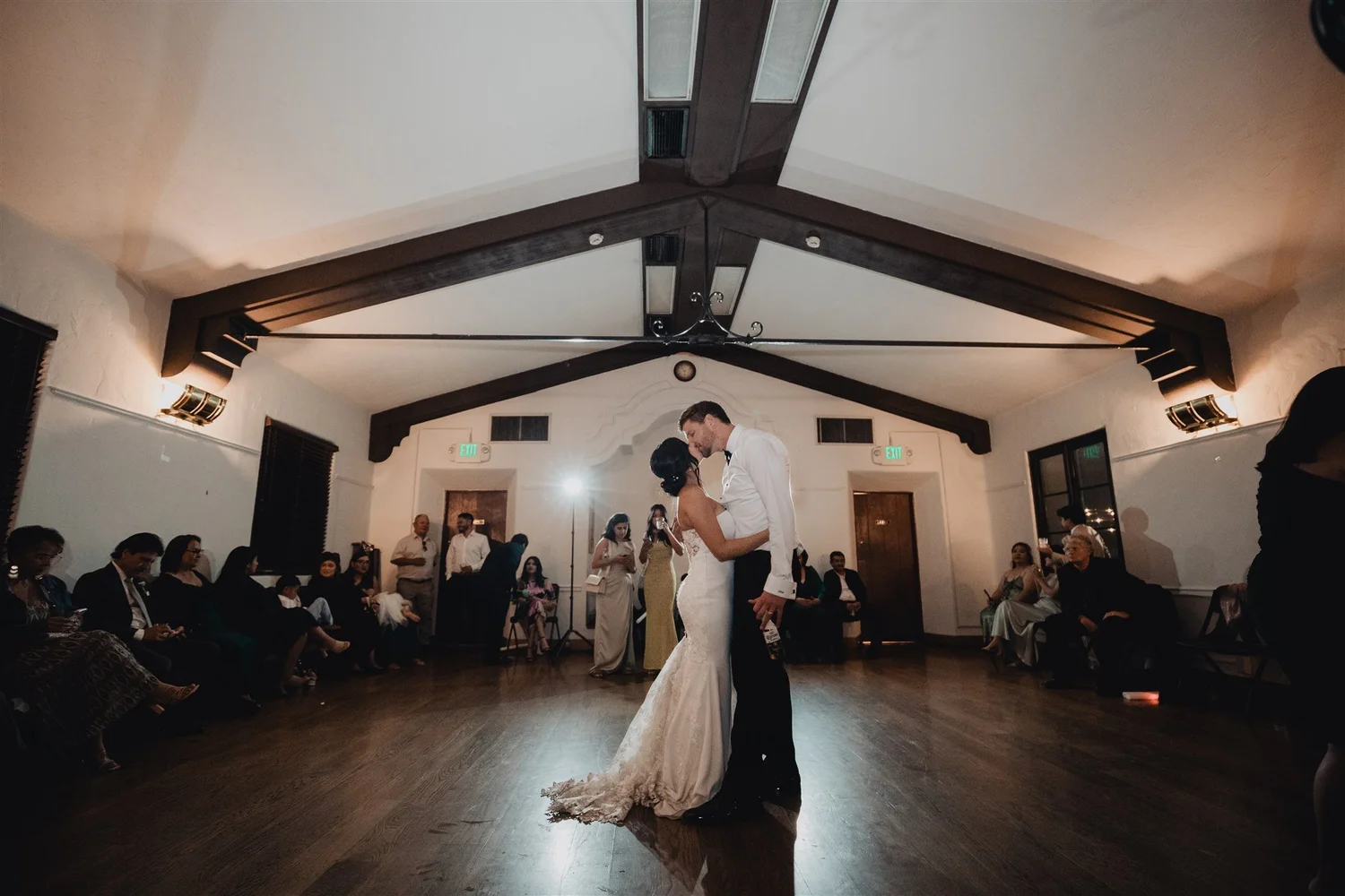 First dance under the dark wood beams of the reception hall at Grapevine Arbor