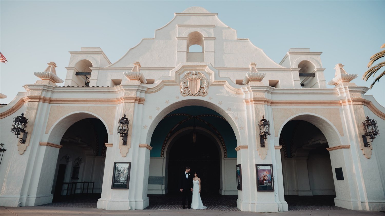 Couple in front of the arched facade of the San Gabriel Mission Playhouse