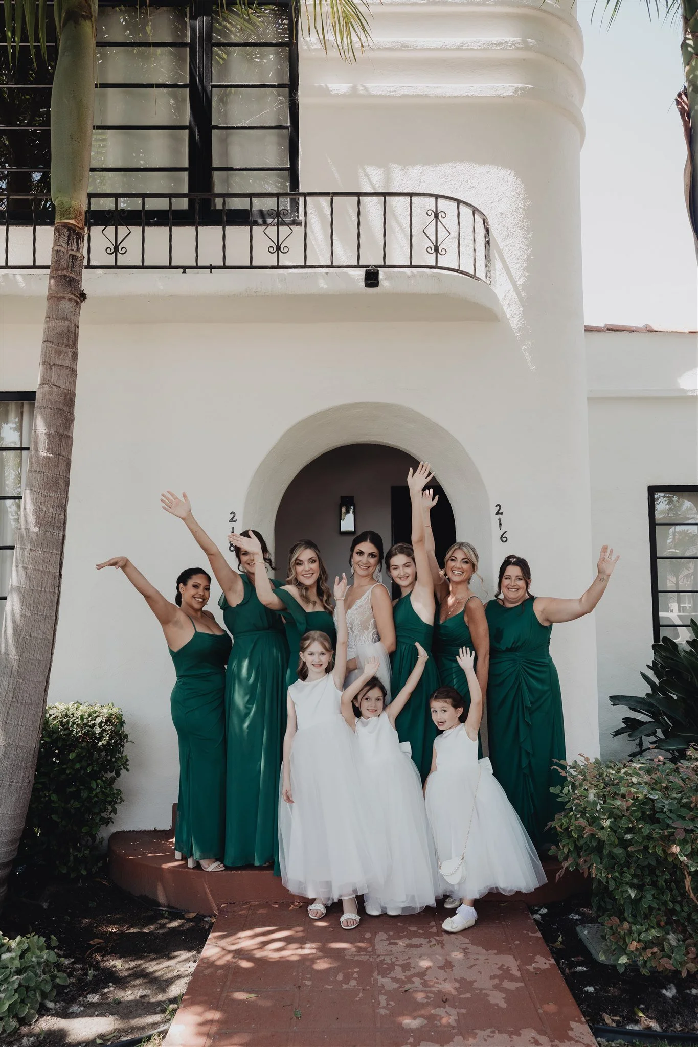 Bridal party celebrating under the white Spanish arches on the Santa Barbara Courthouse grounds