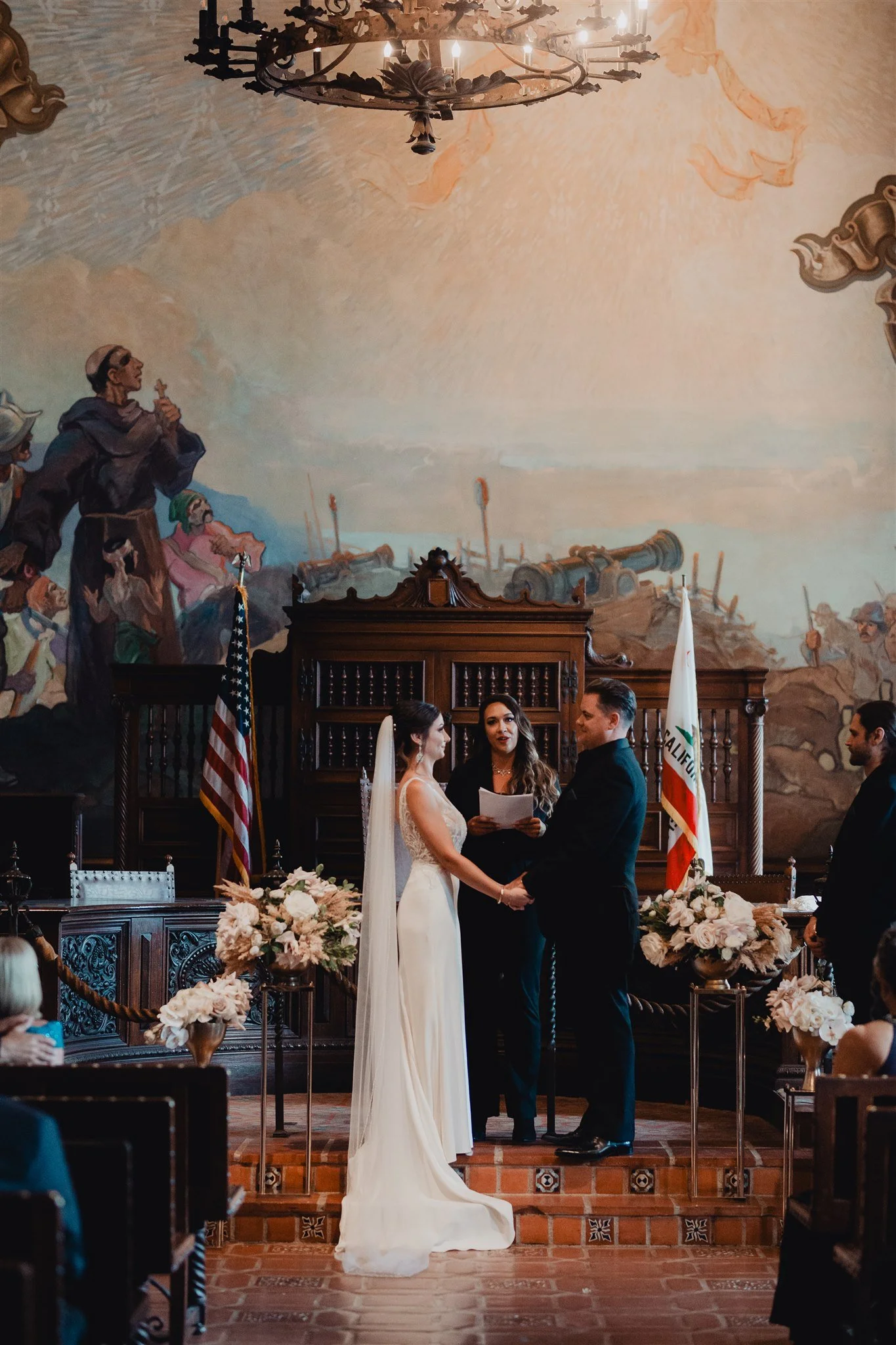 Bride and groom facing their officiant during a Mural Room ceremony at the Santa Barbara Courthouse