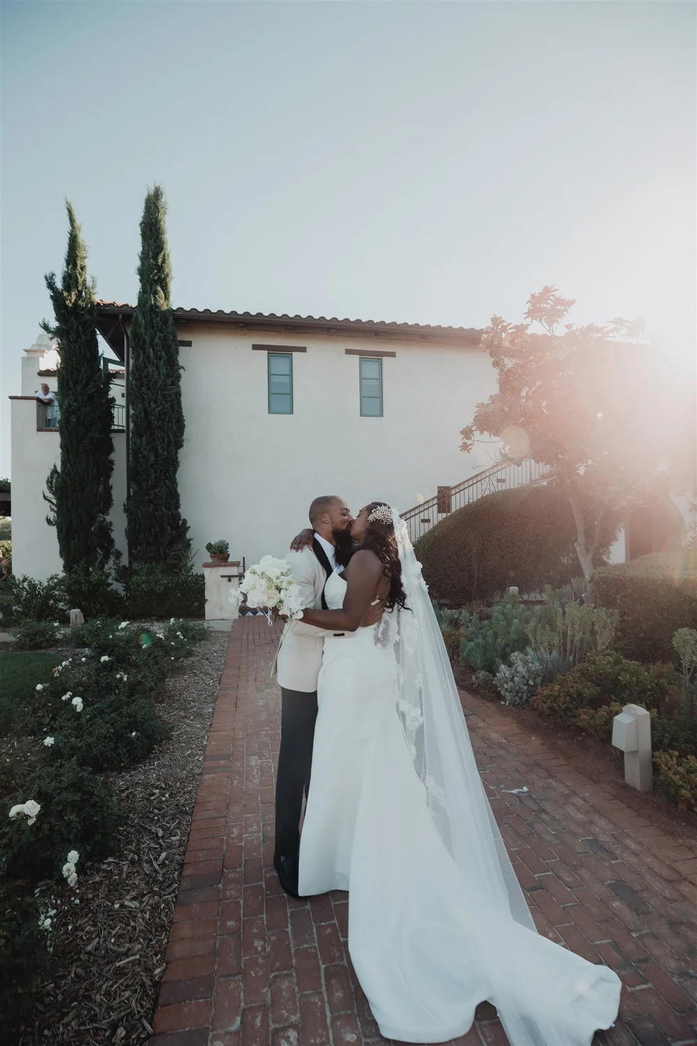 Bride and groom walking hand in hand through rows of vines at Ponte Winery in Temecula wine country
