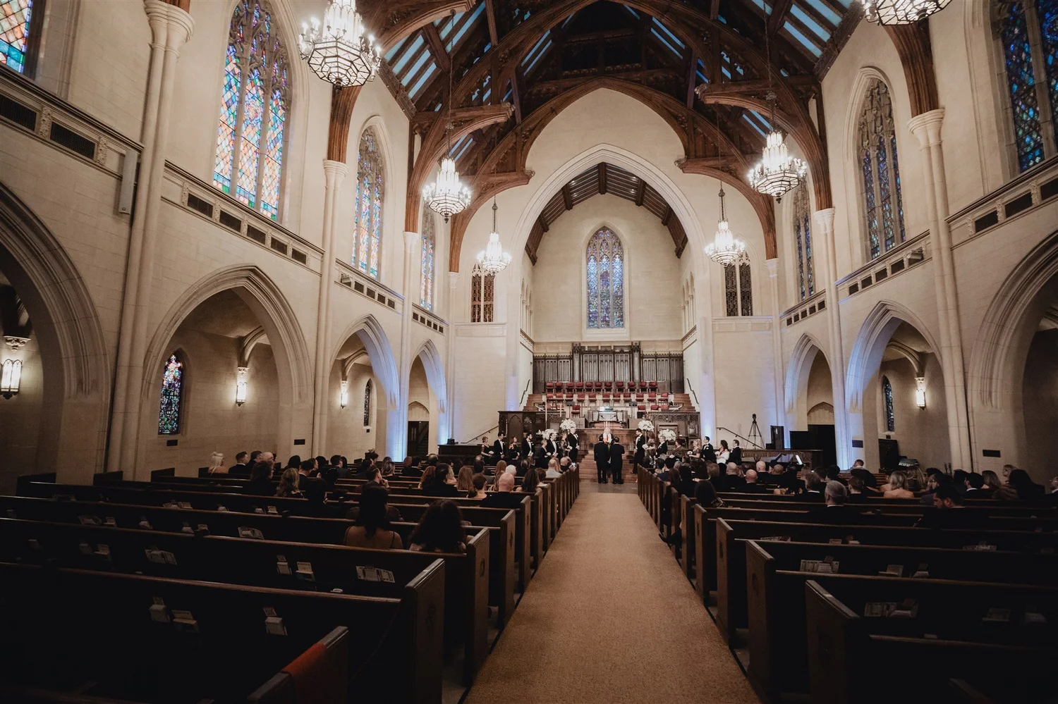 A full church ceremony for two grooms, seen from the back of the Gothic nave at United Methodist Church in Los Angeles