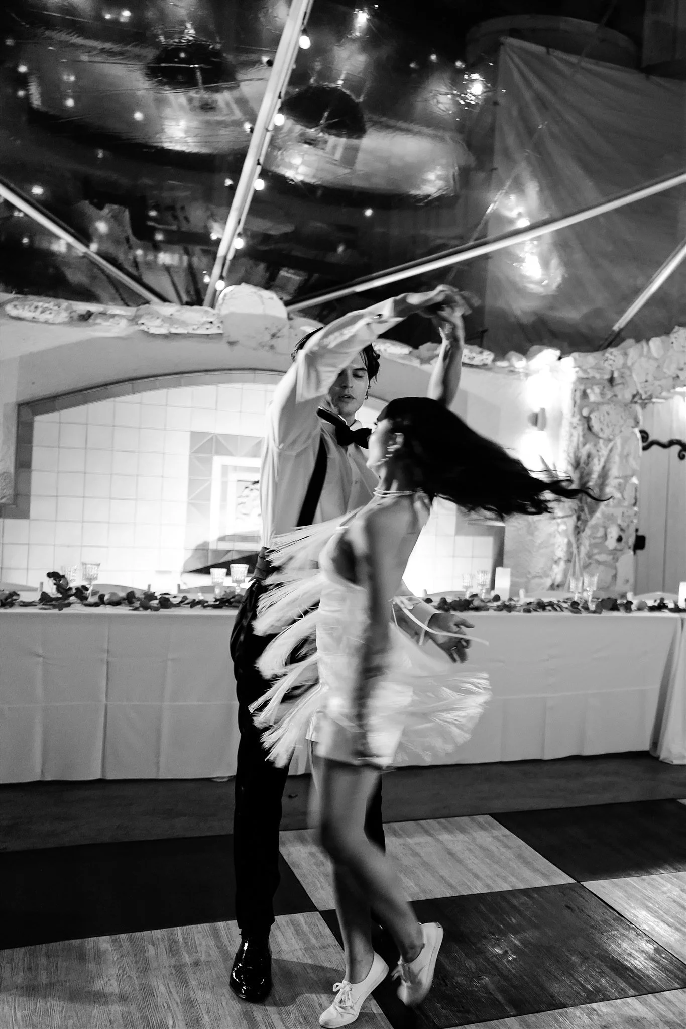 black &amp; white photo of bride and groom during grand entrance at wedding reception