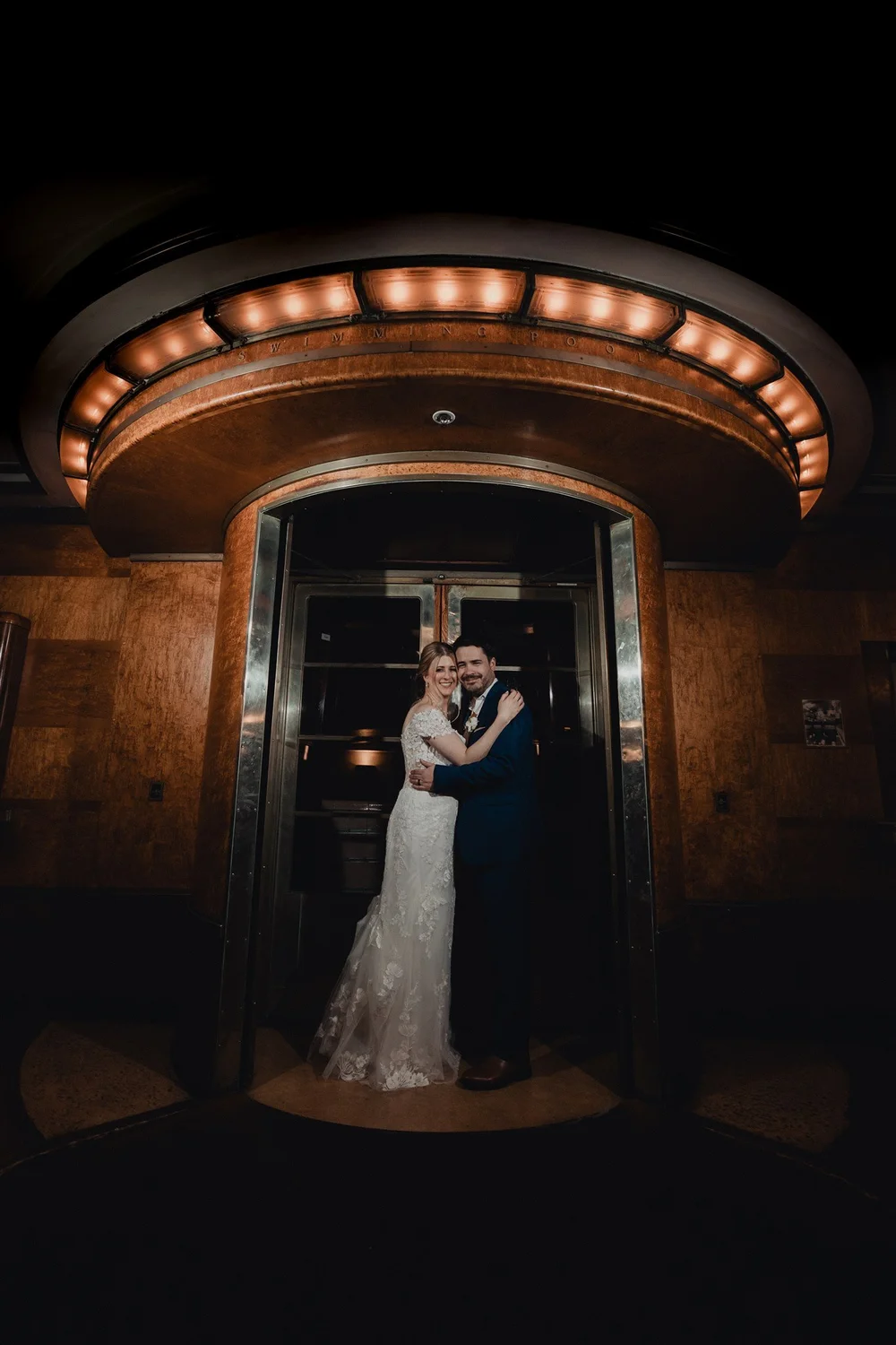 Couple framed in an Art Deco doorway aboard the Queen Mary