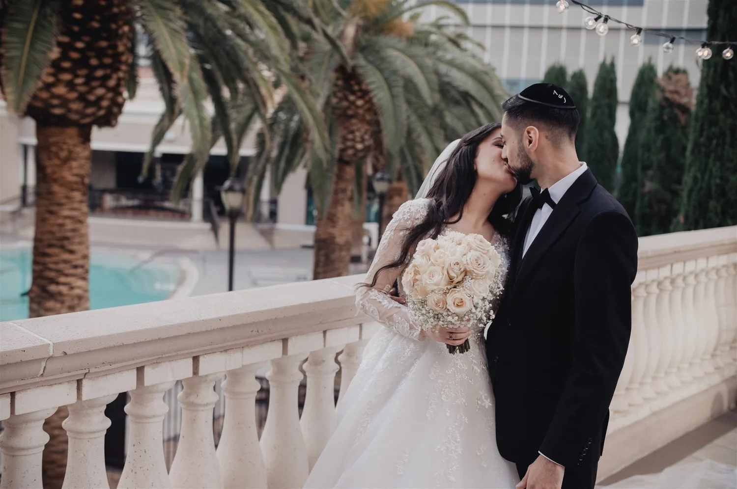 Couple on the balustraded terrace among palm trees at The Stirling Club, Las Vegas