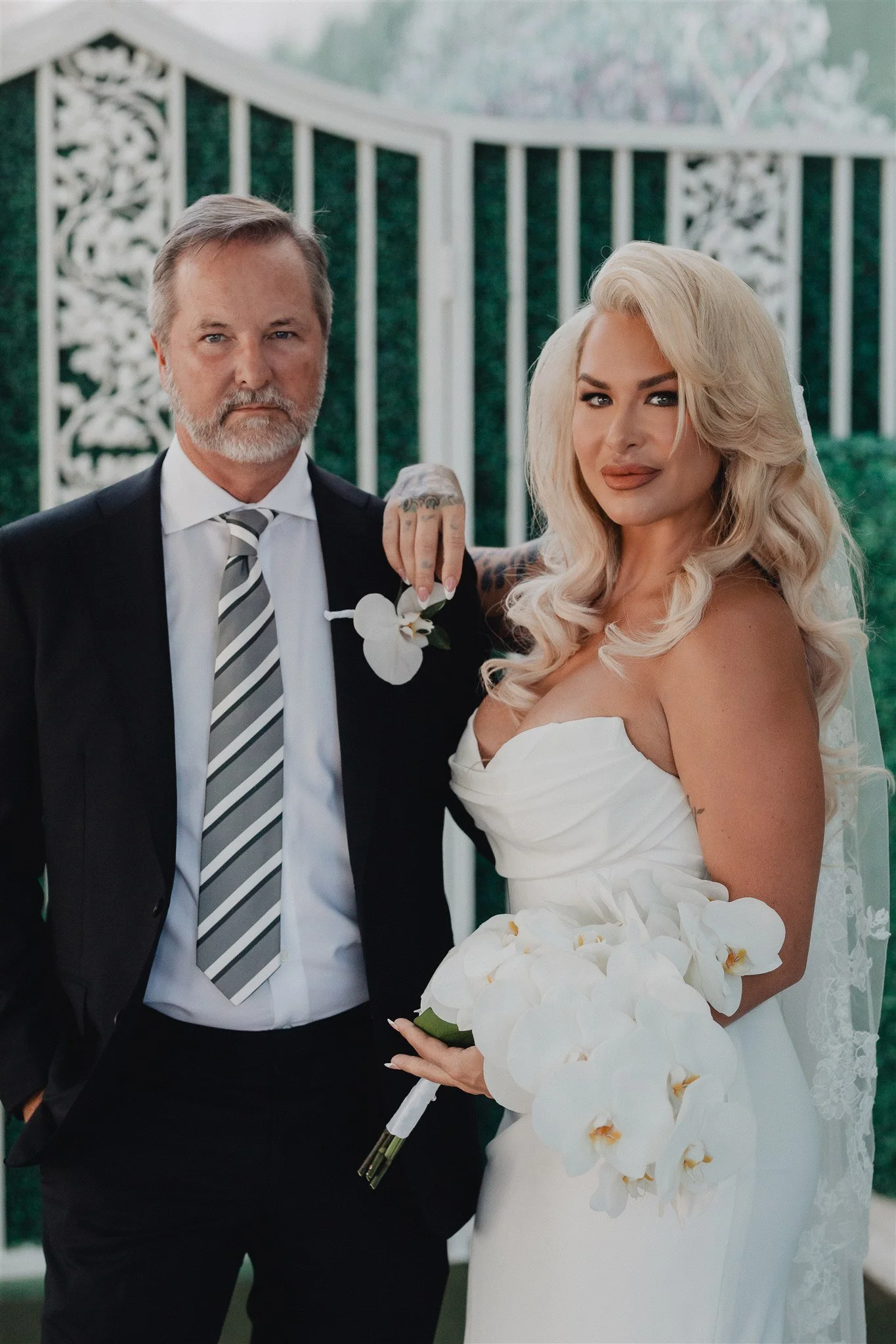 Bride and groom outside a Las Vegas wedding chapel, white lattice gates behind them