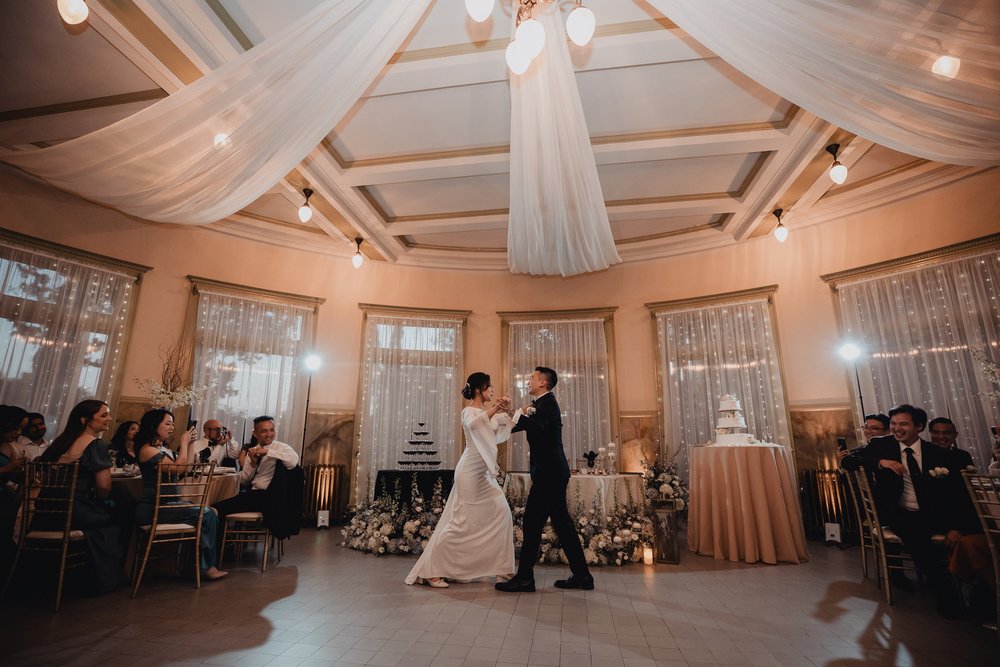 Couple dancing in the round tower room at Castle Green in Pasadena while guests watch from the tables