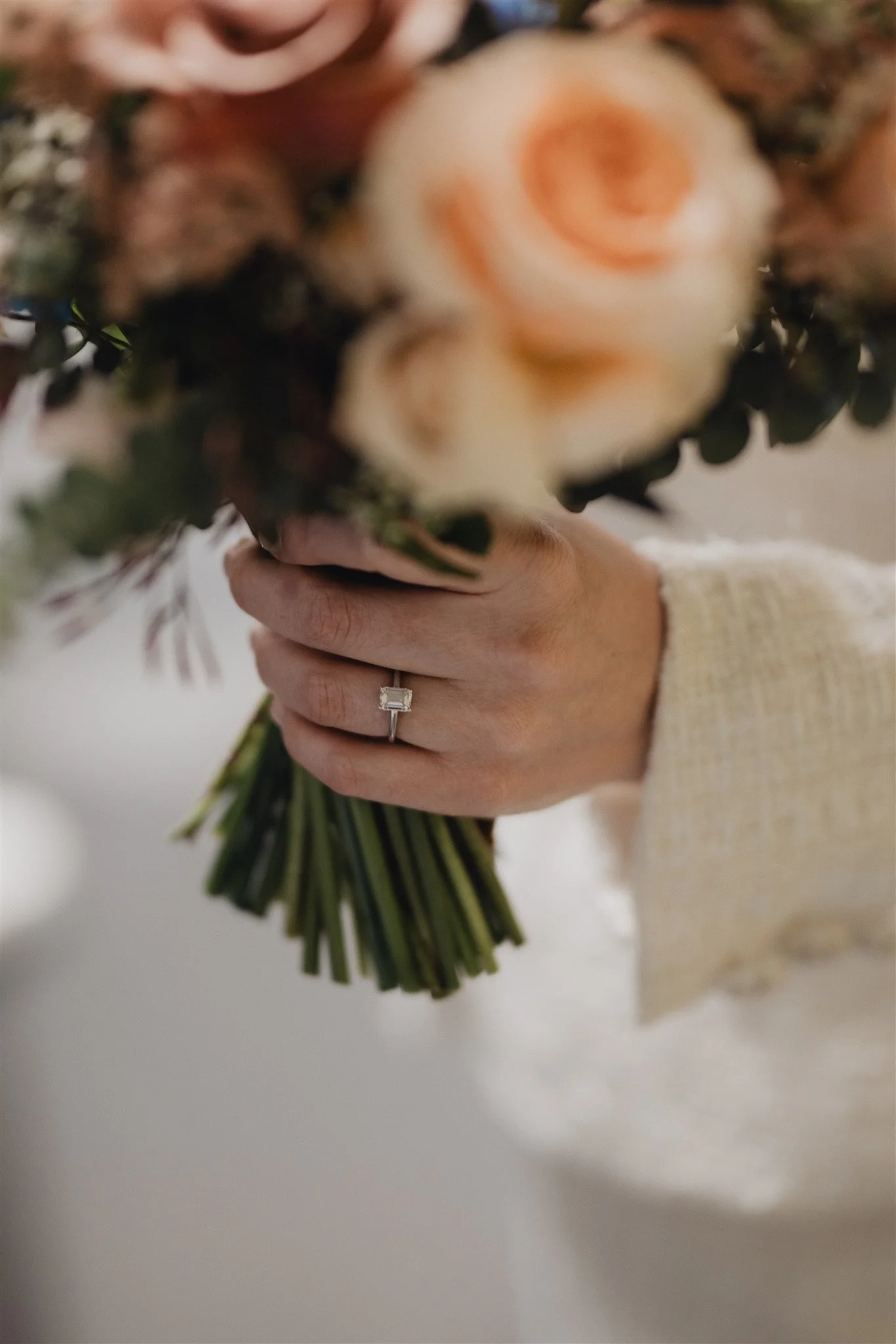 Bridal details laid out before the wedding: rings, bouquet and invitation suite
