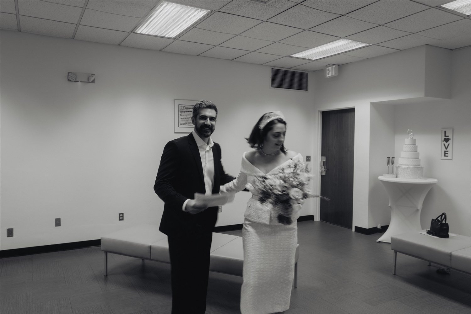 Bride and groom during their civil ceremony inside a Los Angeles County courthouse ceremony room