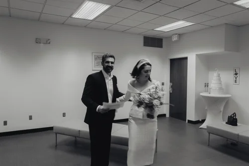 Bride and groom laughing in a courthouse waiting room before their ceremony