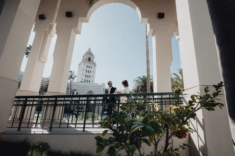 Couple photographed under the arcade at the Beverly Hills Courthouse on their Los Angeles courthouse wedding day