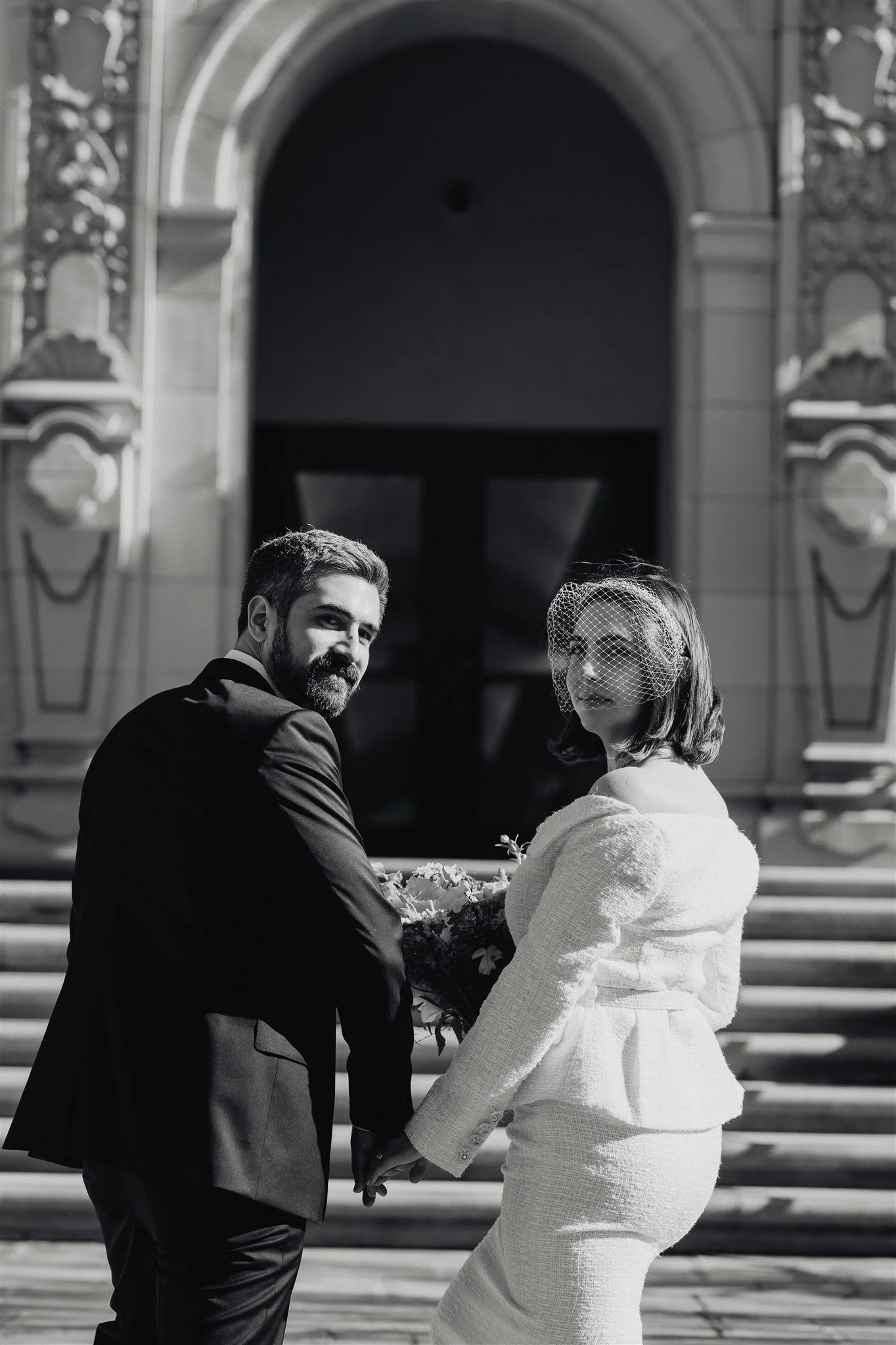 Groom holding his bride on the courthouse steps following their Los Angeles courthouse wedding