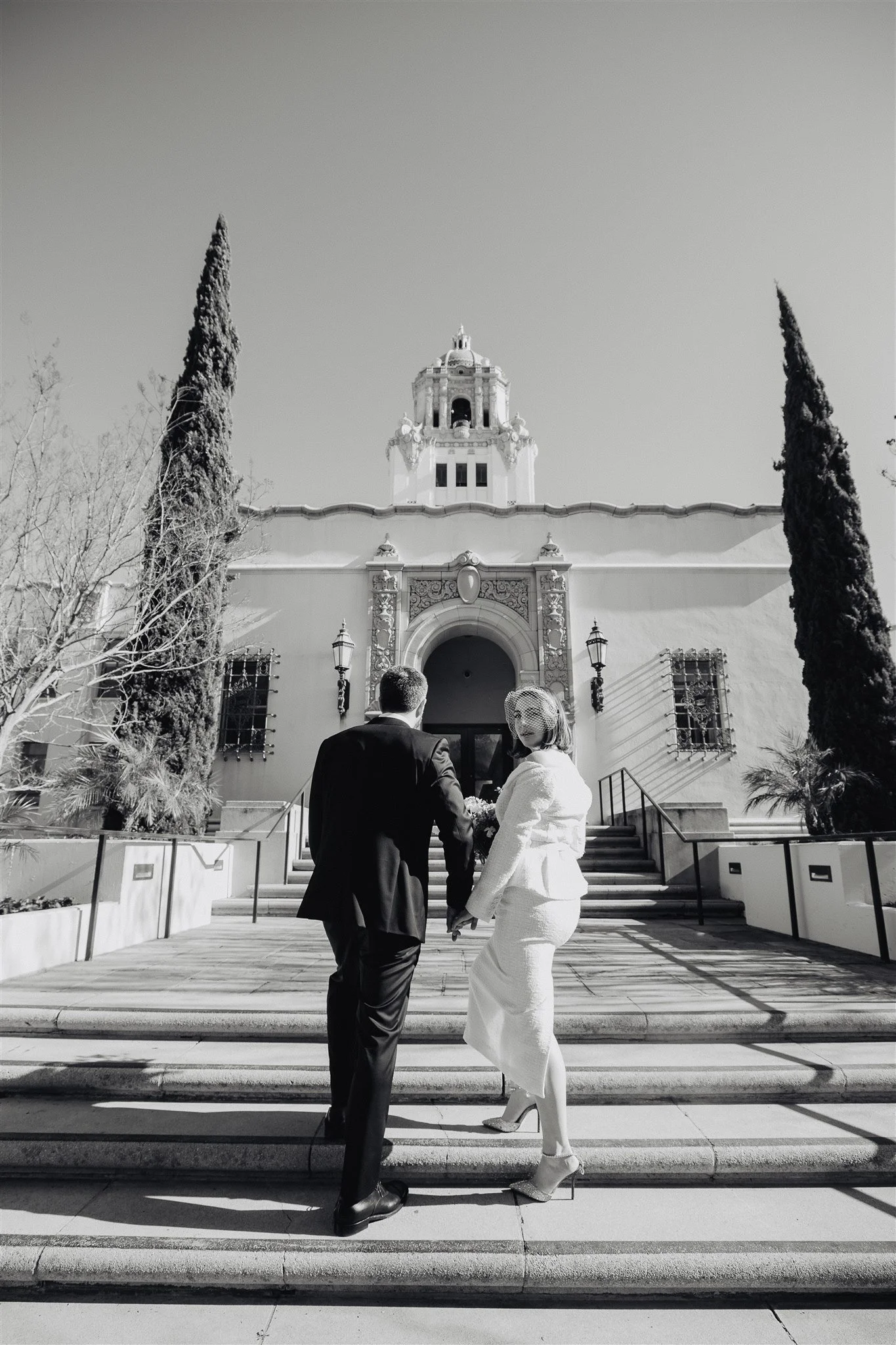 Couple photographed on the steps of Beverly Hills City Hall in black and white after a Los Angeles courthouse ceremony