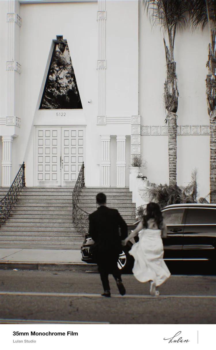 35mm black and white film — couple hurrying up the steps of a Los Angeles landmark