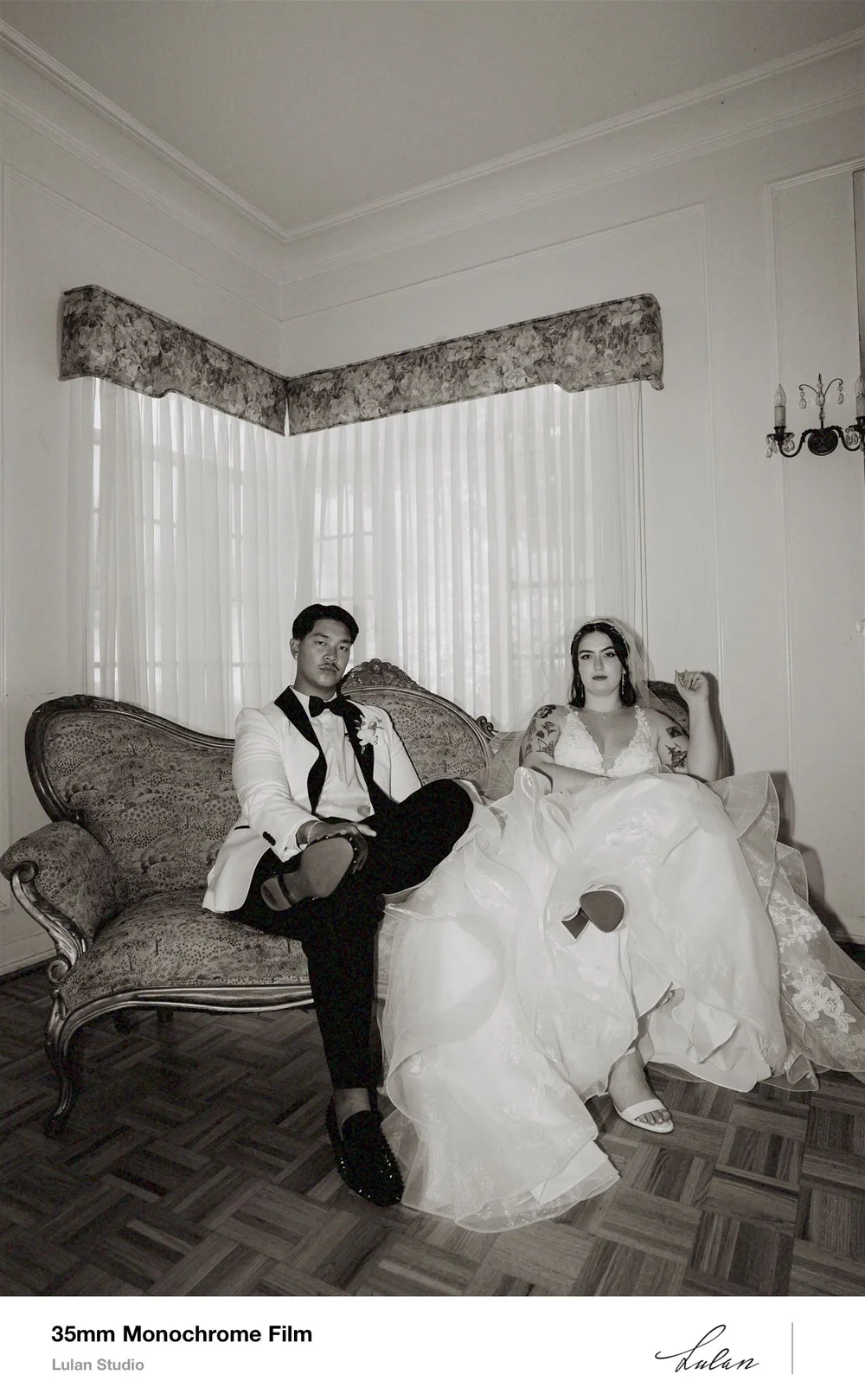 35mm black and white film — couple seated together in a quiet room between events