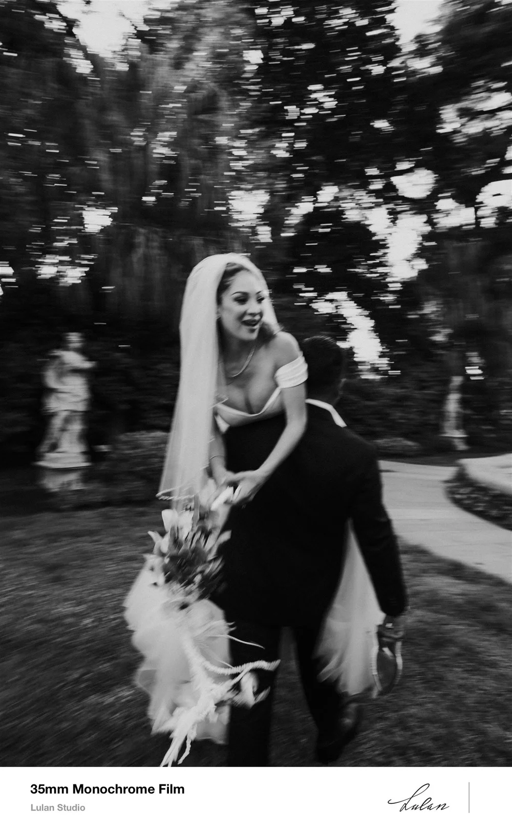 35mm black and white film — bride with her bouquet in dappled garden light
