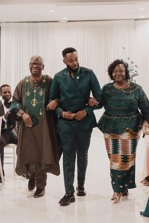 Family in traditional dress walking together after an intimate ceremony