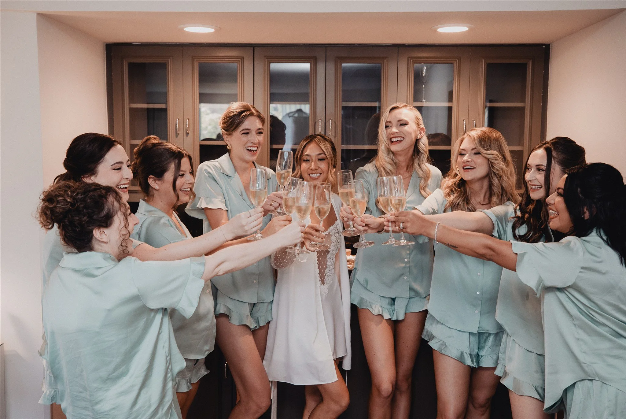 bride and her bridesmaids getting ready robes on her wedding day at skirball cultural center