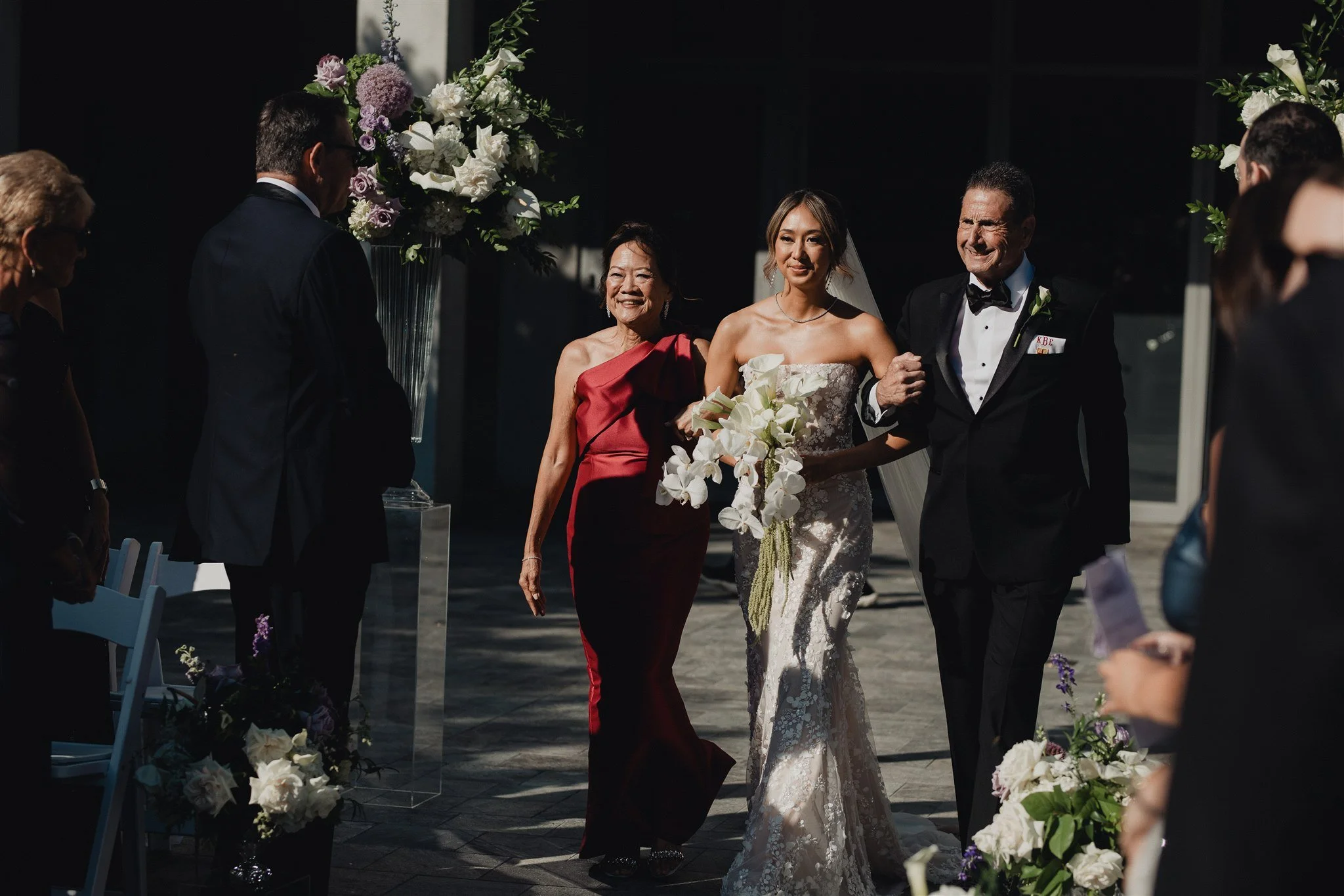 bride walking down the aisle for her wedding ceremony at skirball cultural center