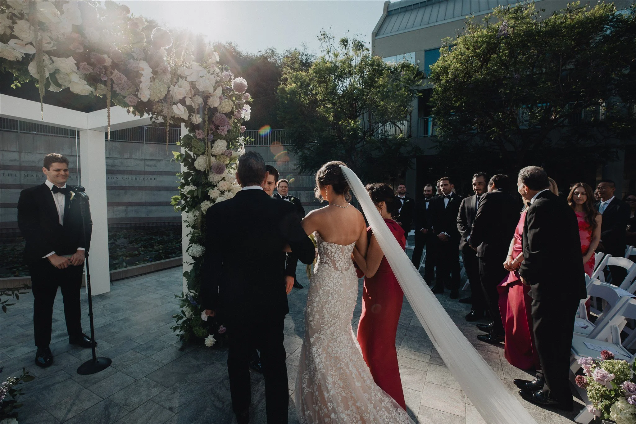 bride walking down the aisle for her wedding ceremony at skirball cultural center