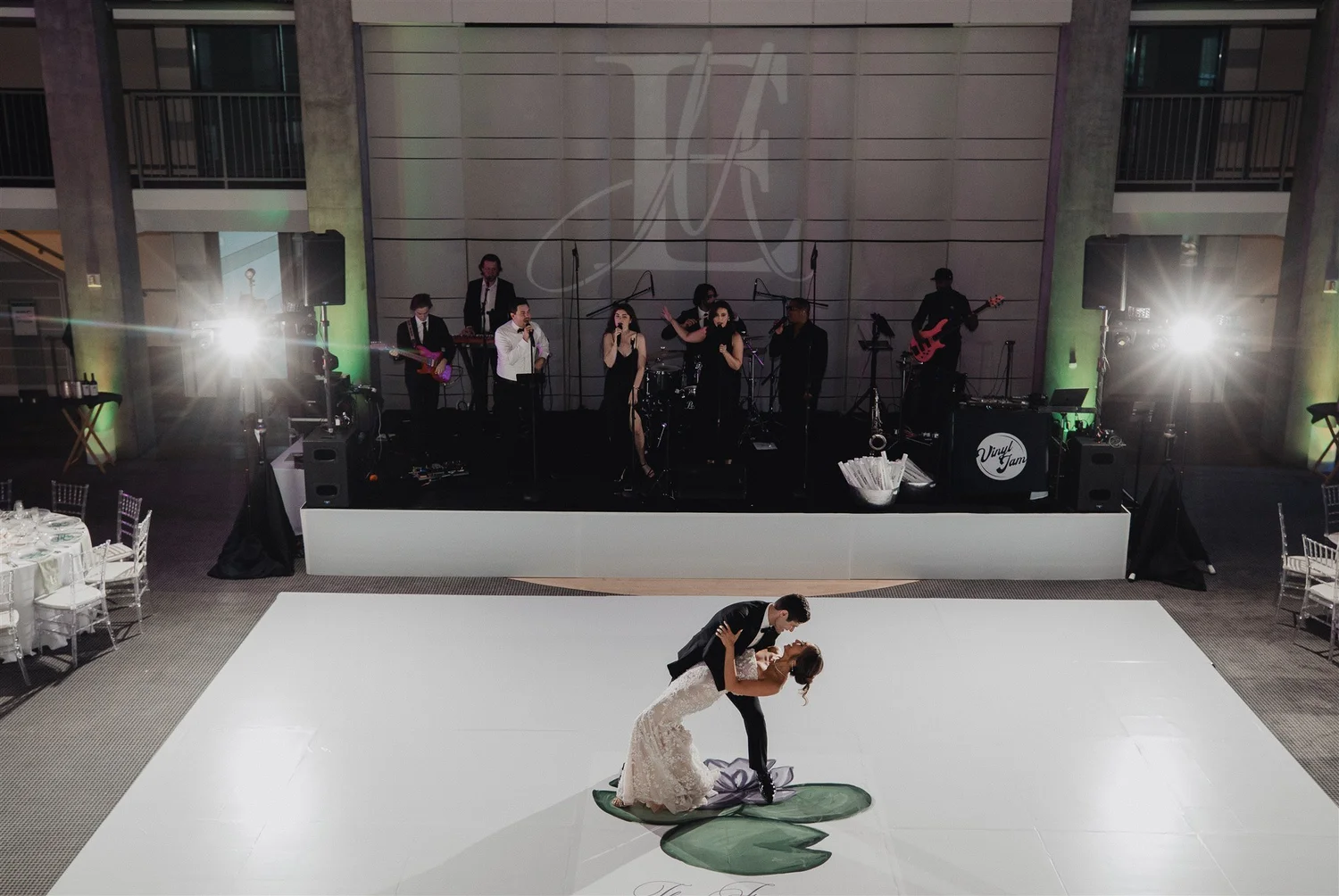A first dance beneath the couple's monogram projected on the wall of their reception