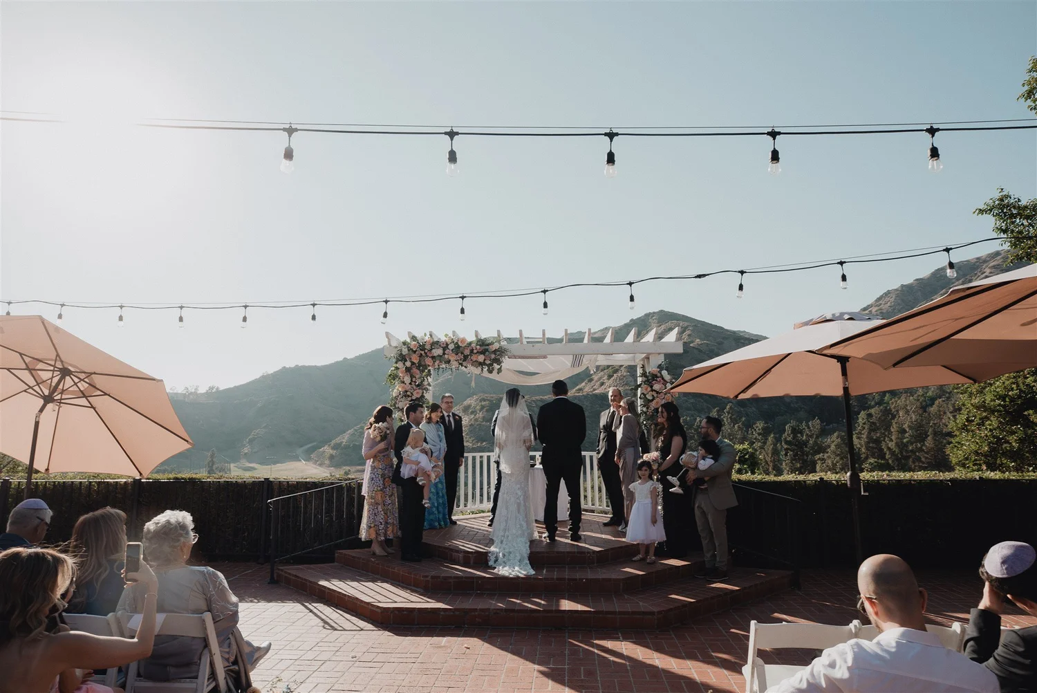 Outdoor wedding ceremony under string lights above the San Fernando Valley, photographed at Castaway in Burbank