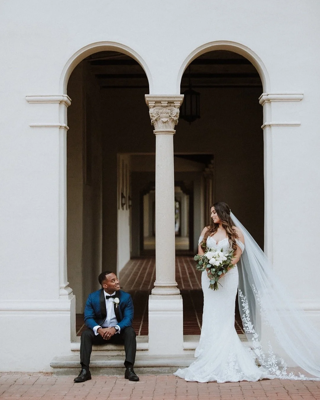 Couple framed by the stone arches at Greystone Mansion in Beverly Hills