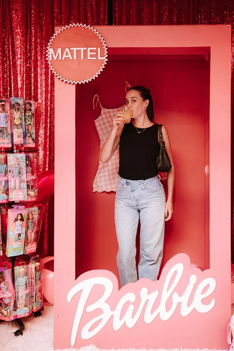 Guest inside a pink branded photo booth