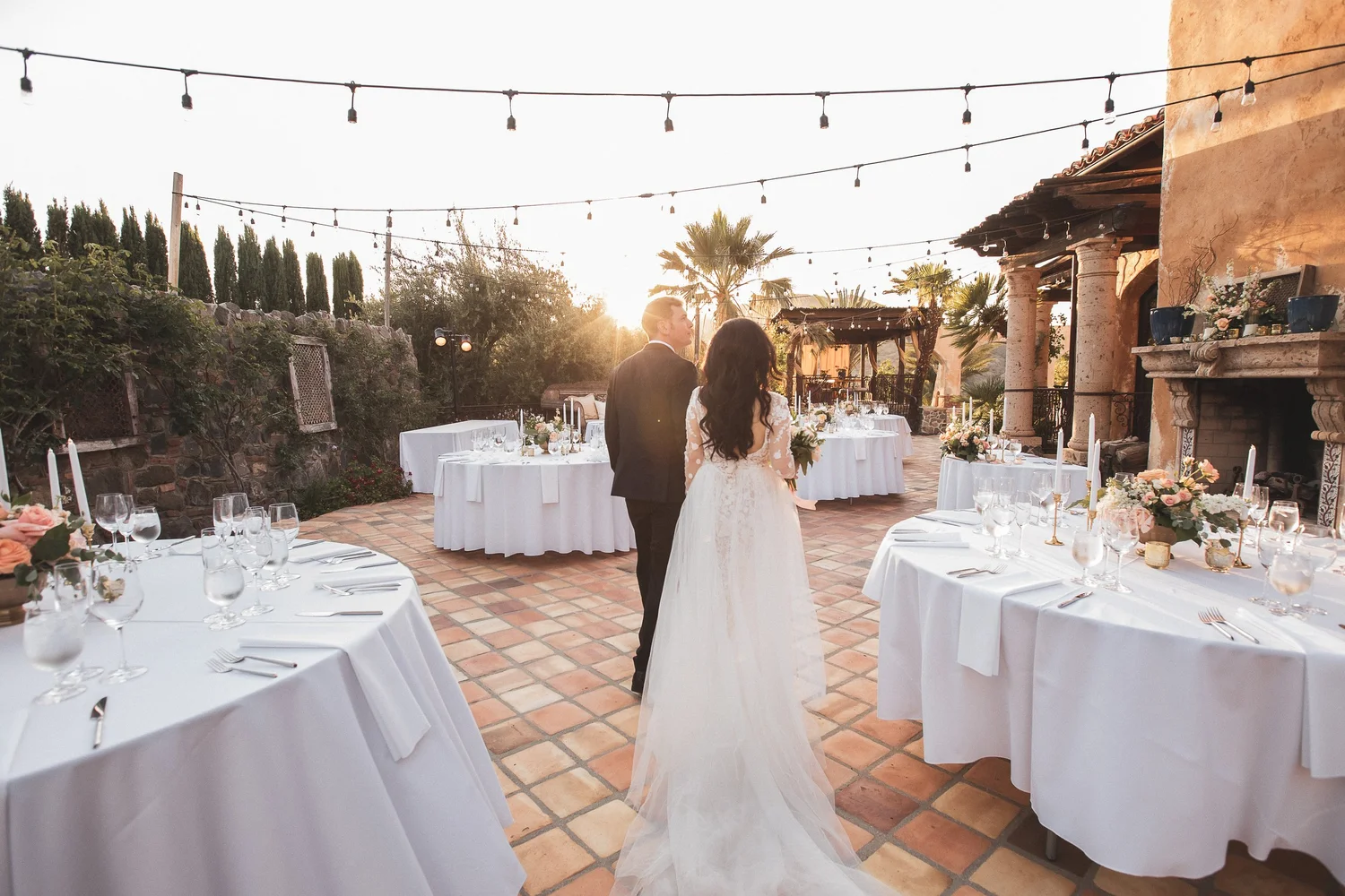 Couple at their outdoor Vietnamese wedding reception at sunset