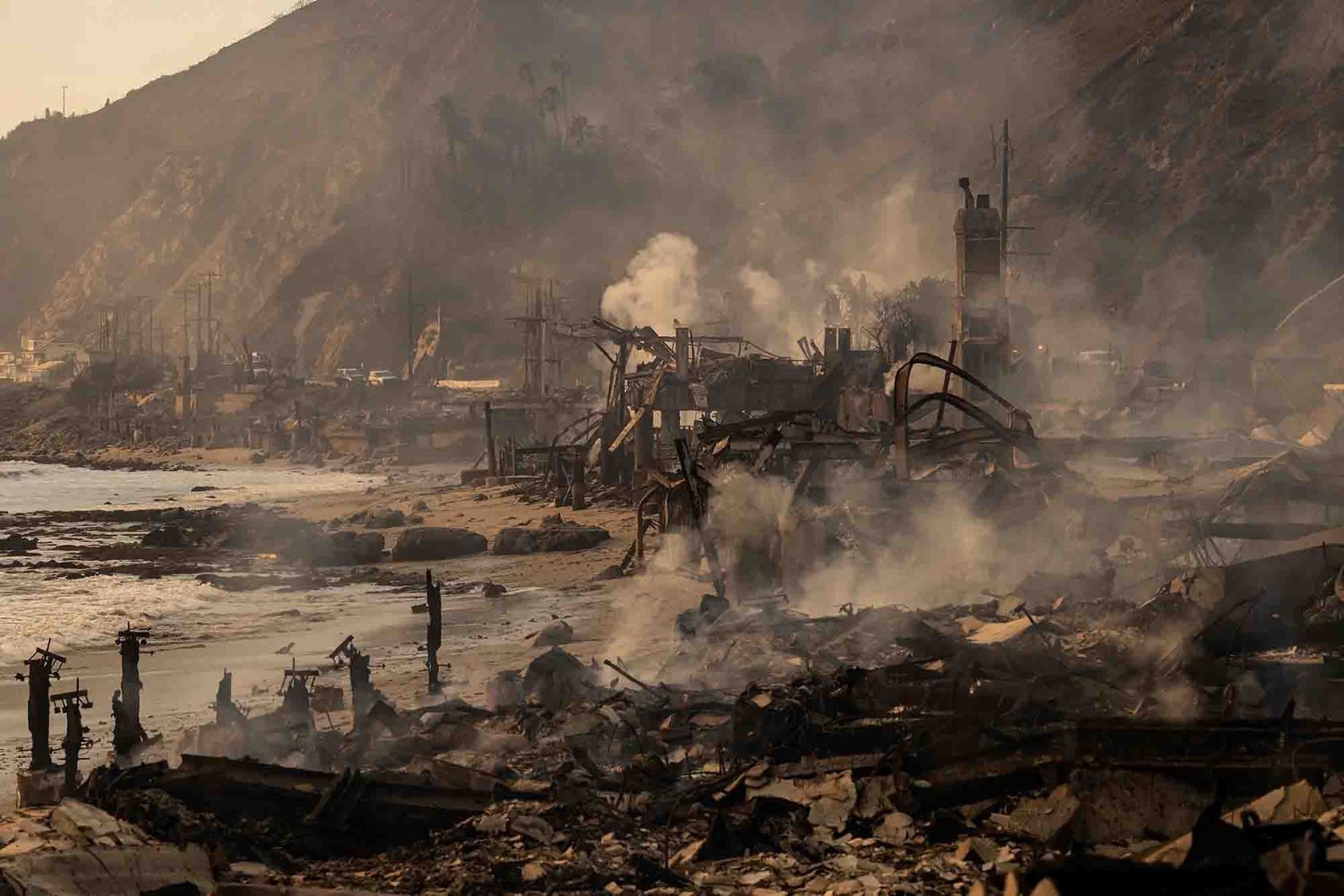 Burned foundations and debris left behind in a Pacific Palisades neighborhood after the January 2025 wildfire