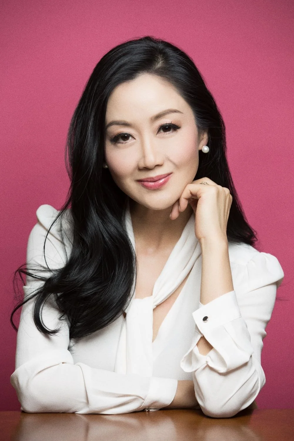 Editorial headshot on a pink background
