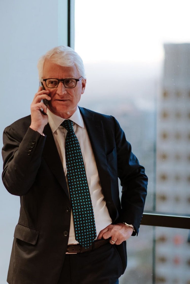 Executive in a dark suit on the phone in a downtown Los Angeles office