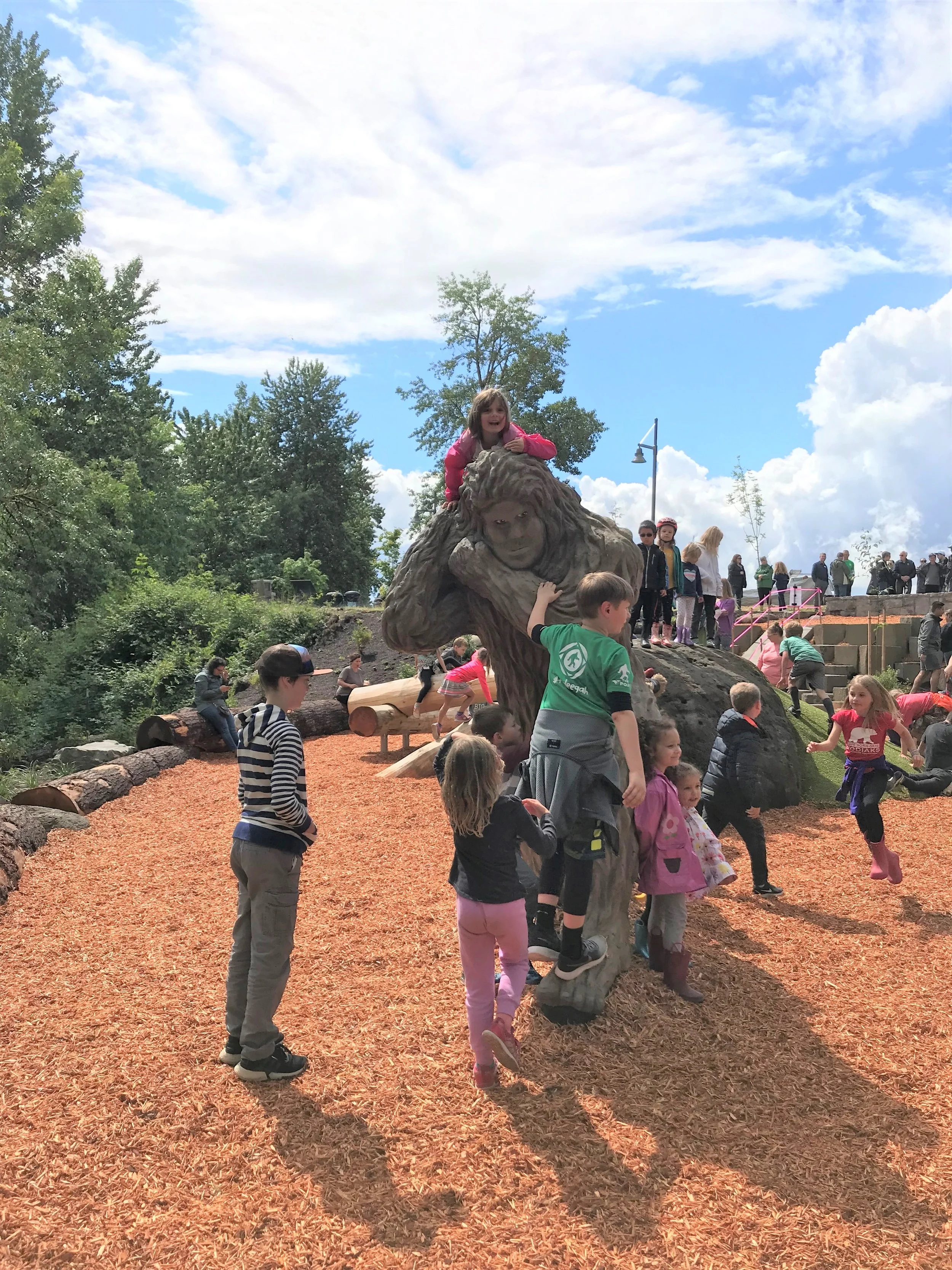 Children play on sasquatch statue named “Eegah”