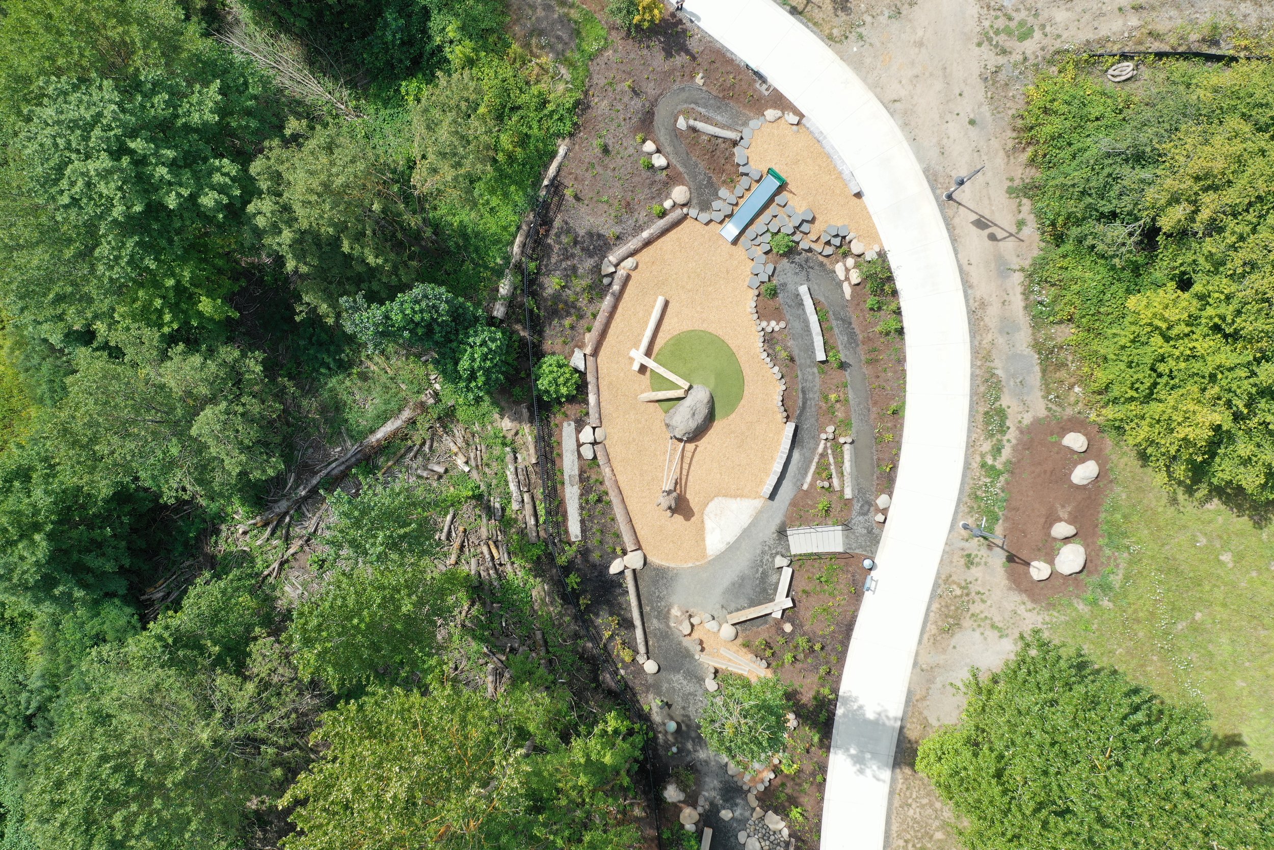 playground, cement pathways, and forest from drone