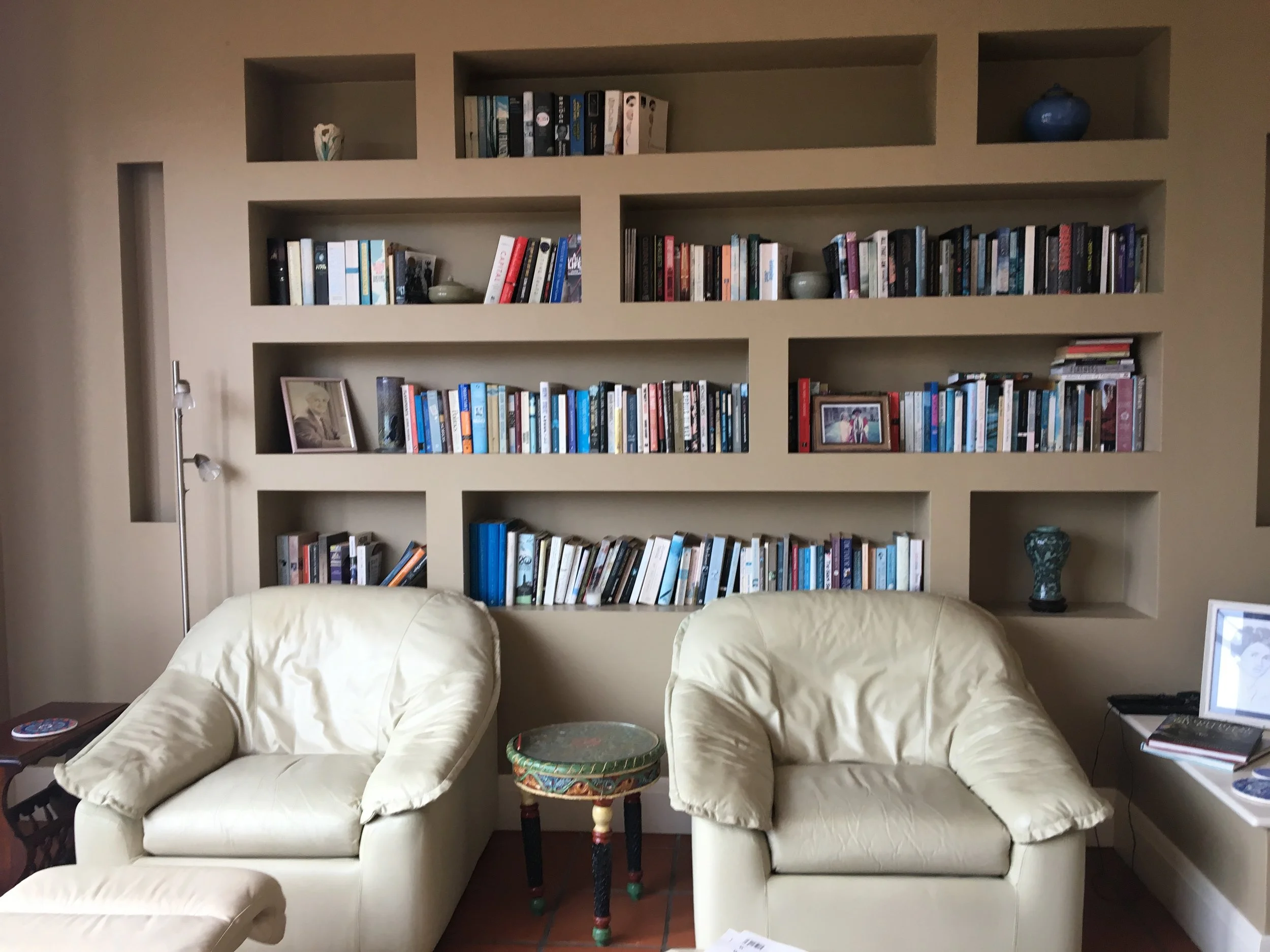 BEFORE. A Mosman sitting room before. The bookshelves were calling for a more contemporary arrangement, but still considering keeping the client’s personal touches involved.