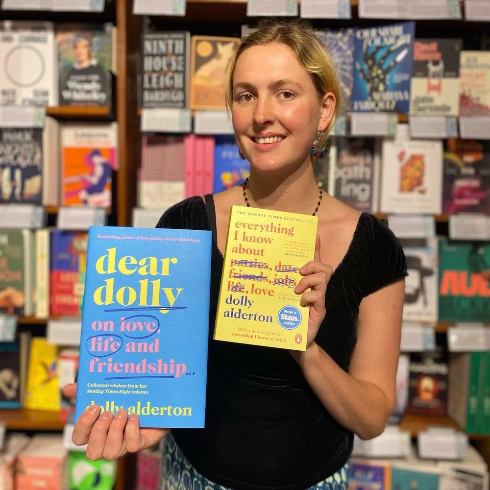 Mary Martin bookseller Erica holding Dear Dolly and Everything I Know About Love by Dolly Alderton