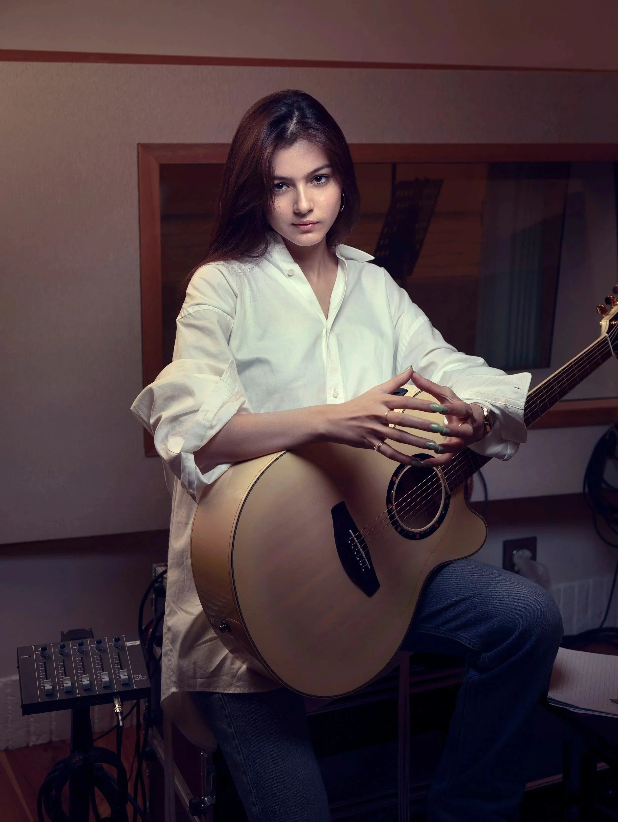 Celine musician portrait photography with an acoustic guitar in a recording studio