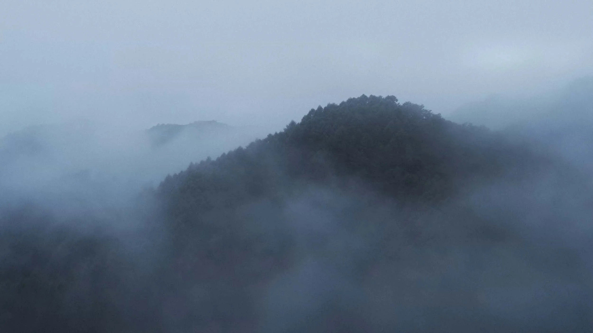 Drone shot of misty mountains near Kyoto from the ROKU KYOTO hotel brand film