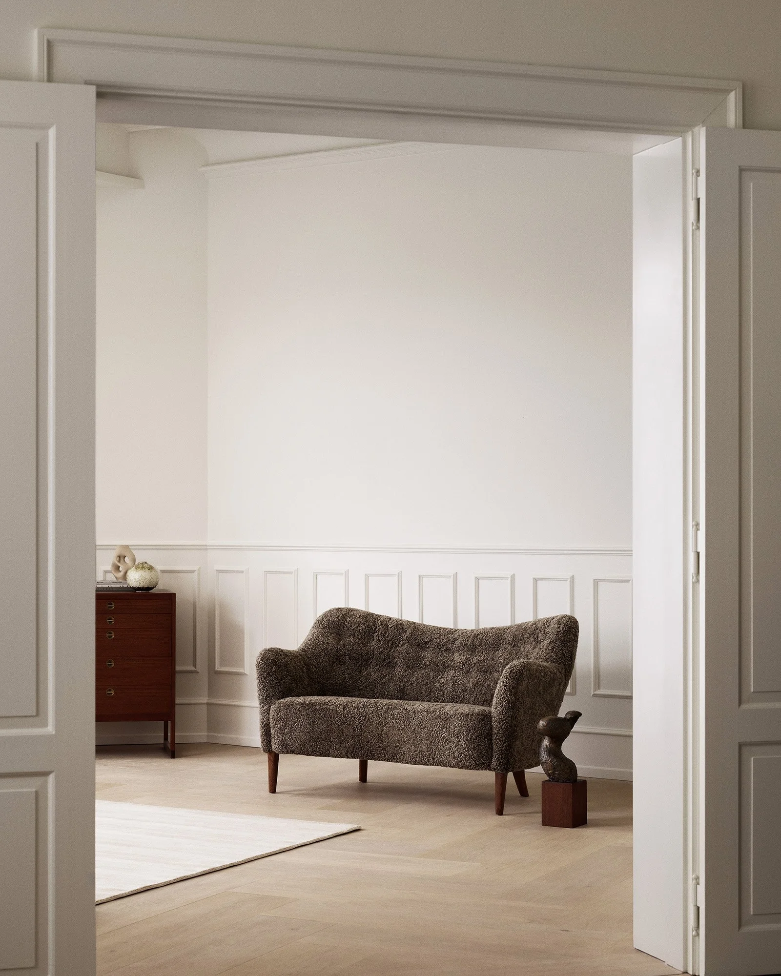 Dagmar's Tisso loveseat sofa by Alfred Christensen with curved design and sheepskin upholstery, a re-edition of the classic 1940s Danish cabinetmaker piece