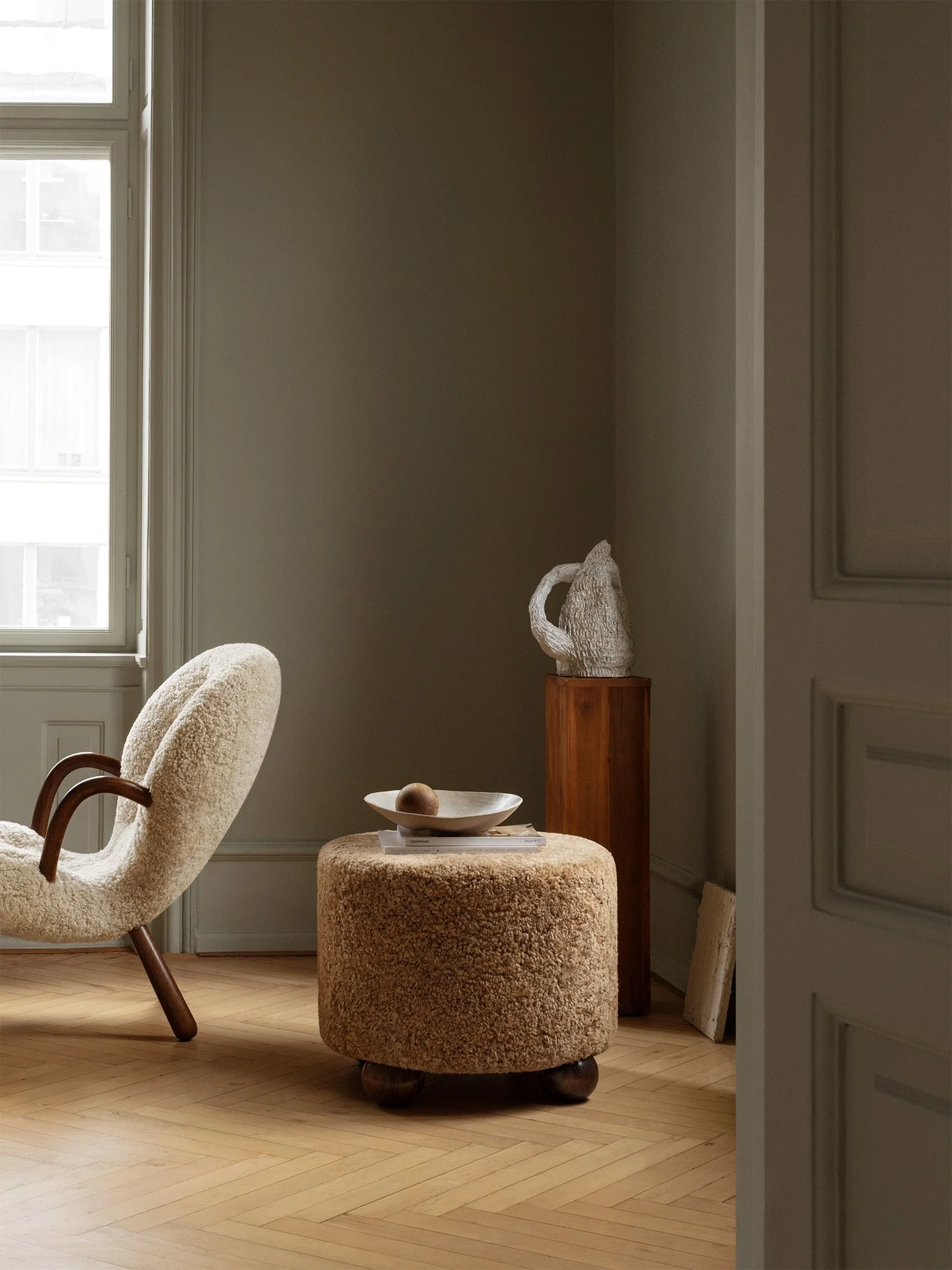 Dagmar's Luupo ottoman in sheepskin upholstery with solid wood frame, part of their classic Scandinavian Modern furniture collection