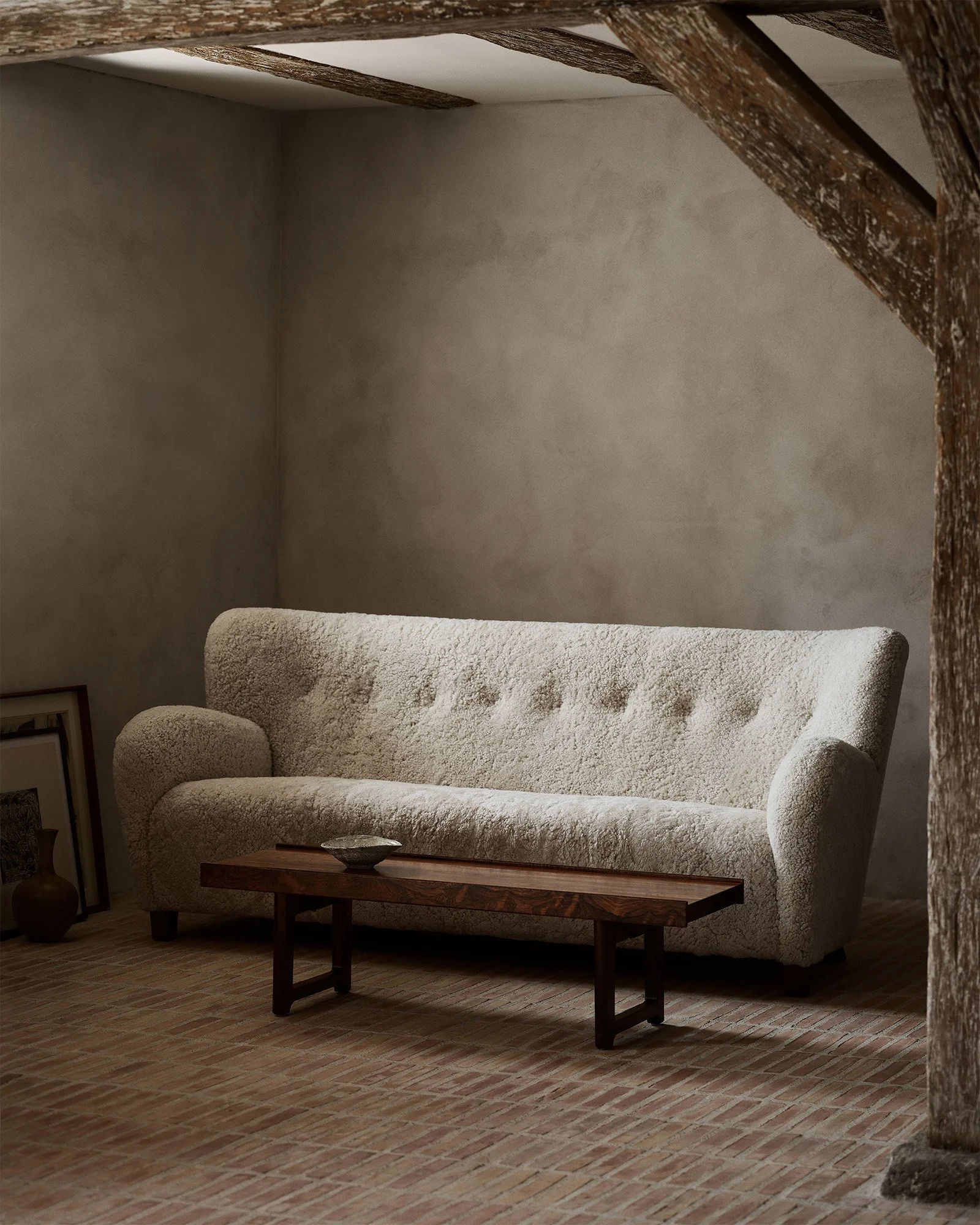 Dagmar's Karu sofa with curved arms and winged back in sheepskin upholstery on solid beech wood frame, a contemporary update of 1940s Finnish design by Haimi Oy