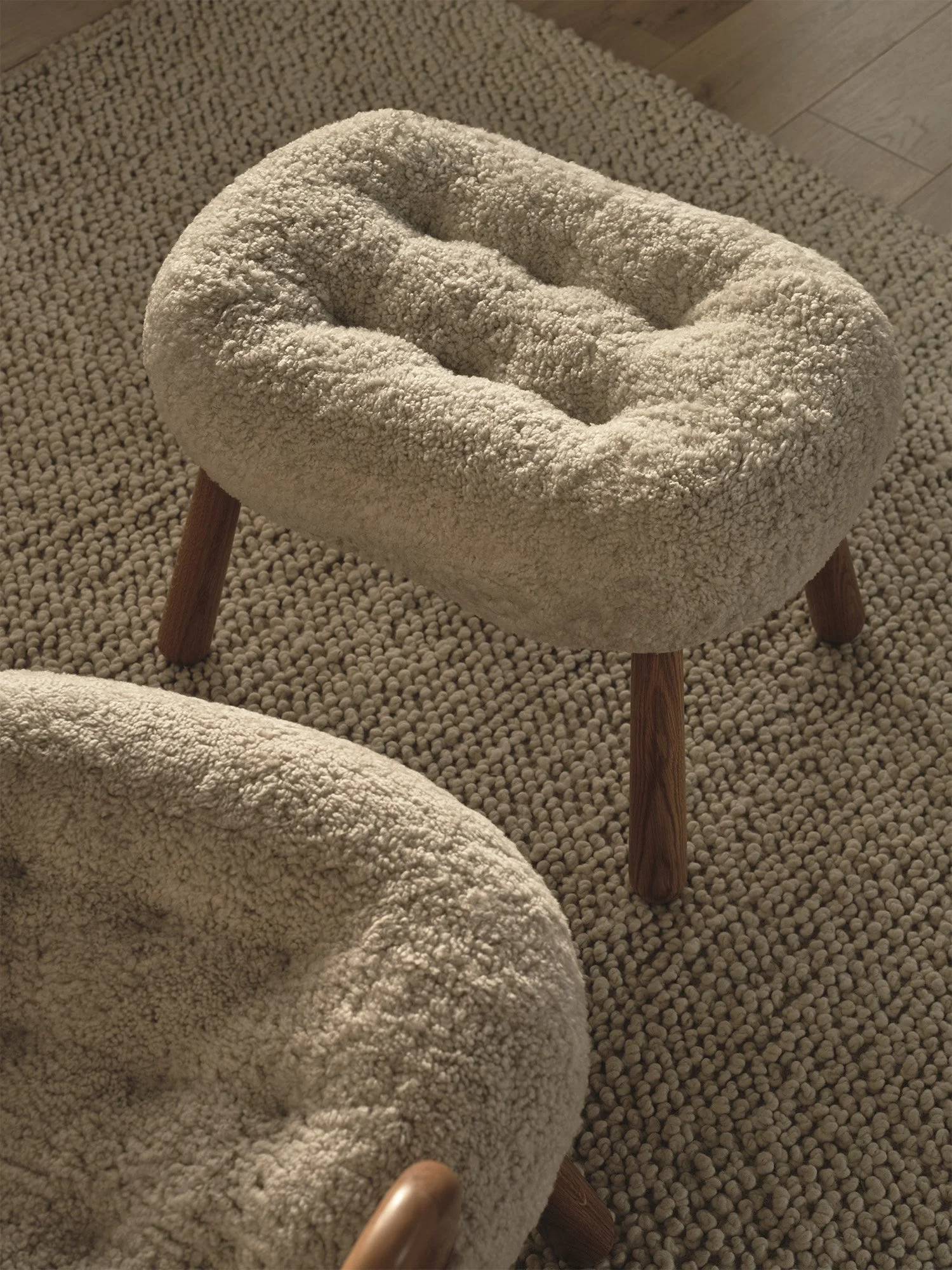 Arnold Madsen's Clam footstool by Dagmar with sculptural shell-like form in sheepskin upholstery, the perfect companion piece to the iconic Clam chair