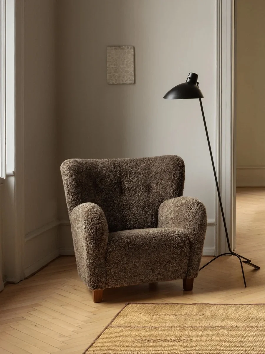 Dagmar's Karu chair with curved arms and winged back in sheepskin upholstery on solid beech wood frame, a contemporary update of 1950s Finnish design