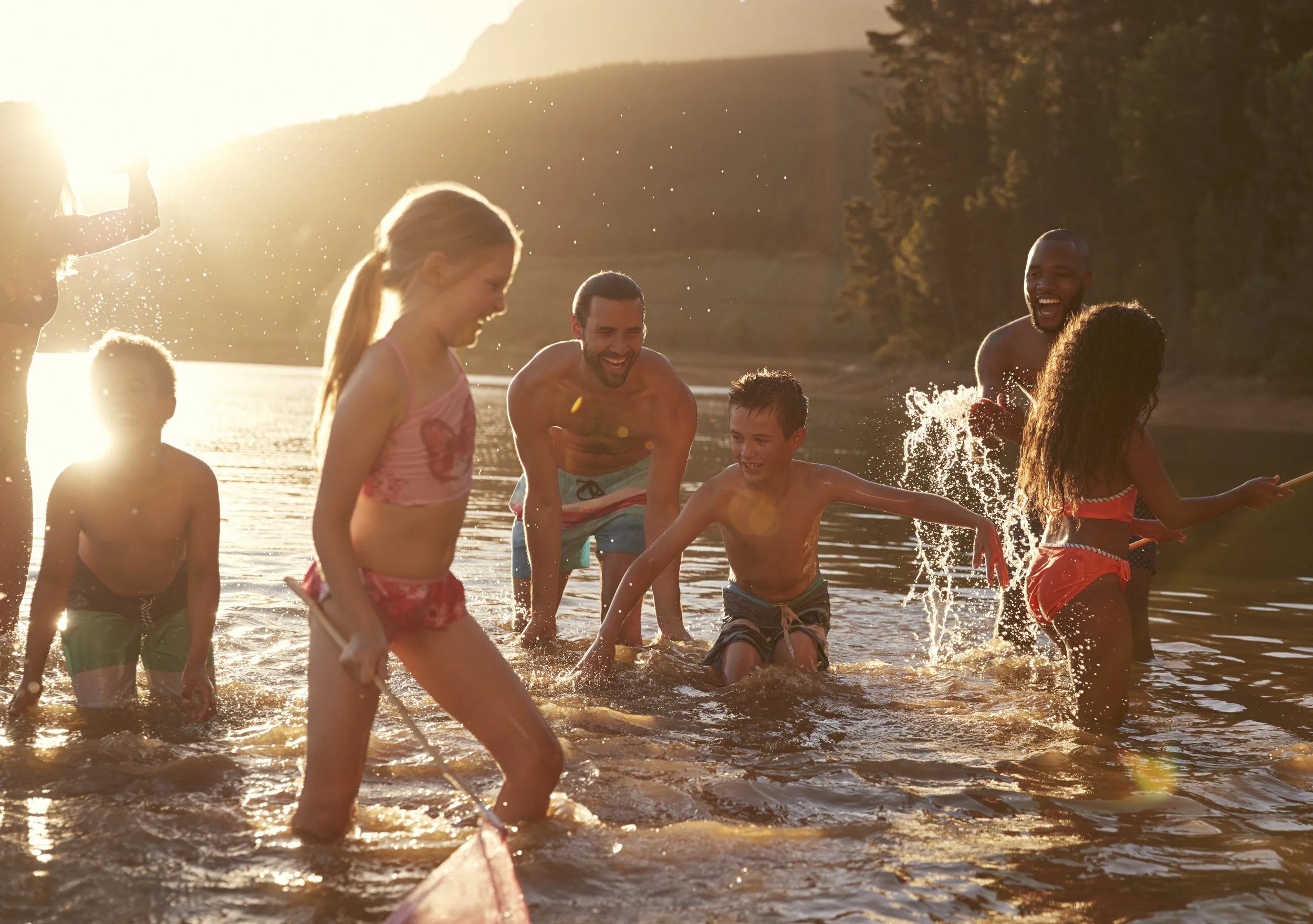 family-with-friends-enjoying-evening-swim-in-NSYKQZC.jpg