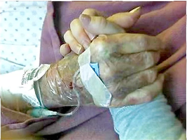 This is a picture of me holding my Dad’s hand when he was sick – looking at it reminds me every day, like every word that is written on your shirt, to love this life...it’s the only one we have and it effects and affects so many. Most of all…he rocked – me as a baby, my world as a teenager, and I rocked him…to sleep before he died.